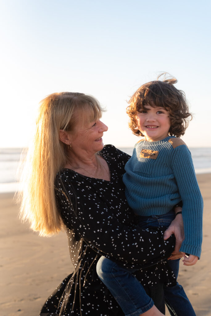 Grandma and grandson on Oceanside beach during a family photo session