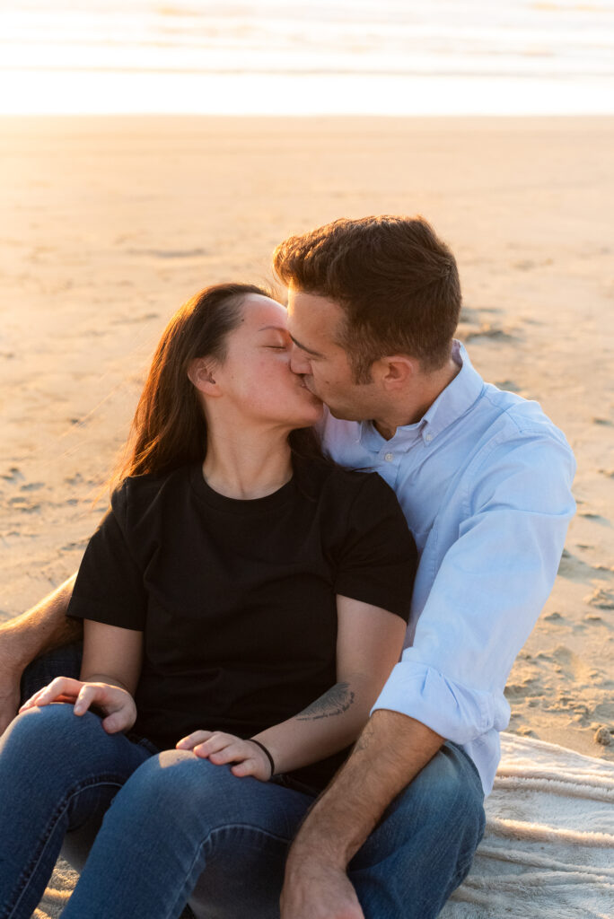 Couple kissing at beach by San Diego Photographer