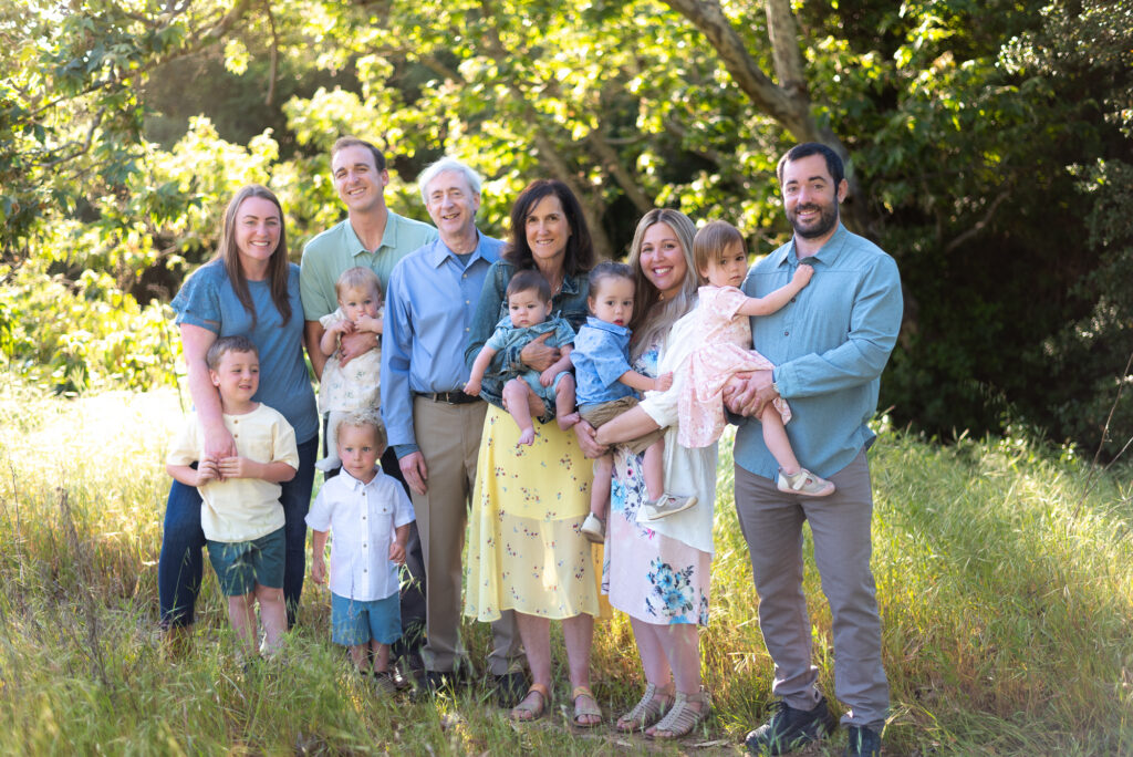 Extended family stands in a spring field for photography session at Marian Bear Park in San Diego