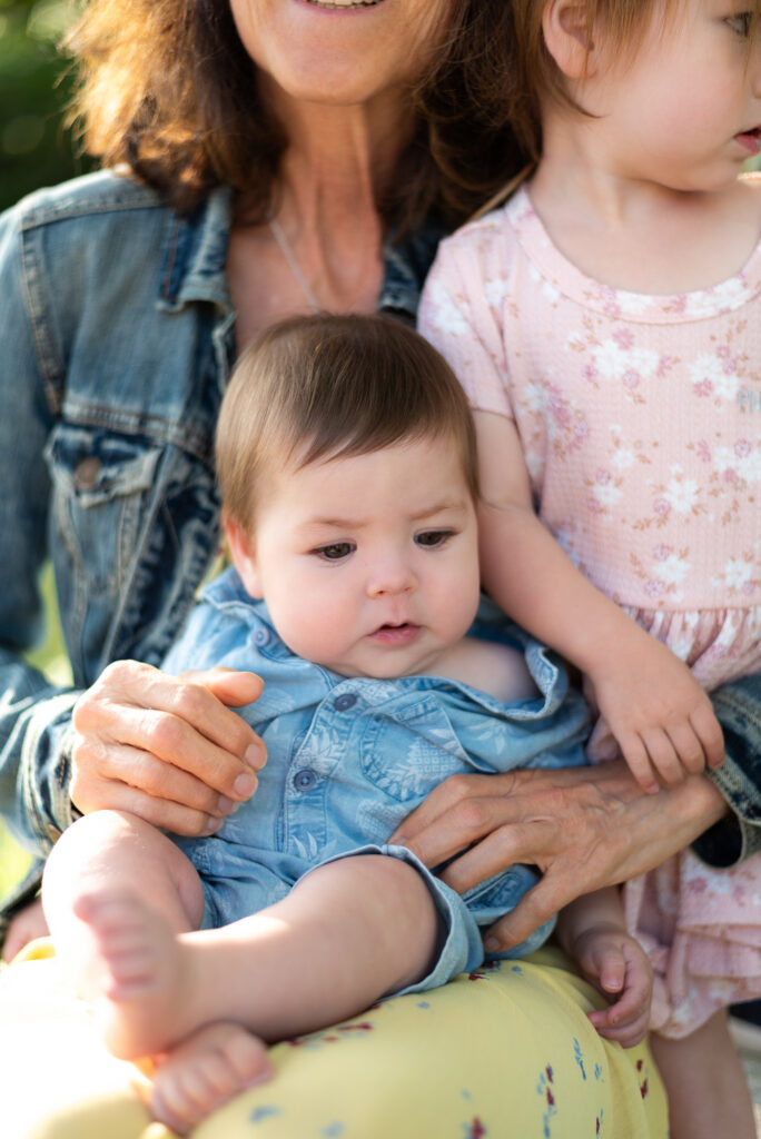 A baby sitting on the lap of his grandma at Marian Bear Park, San Diego