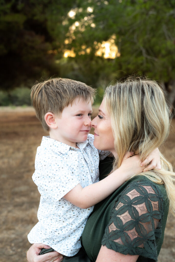 A mom and son touch noses in an emotional photo