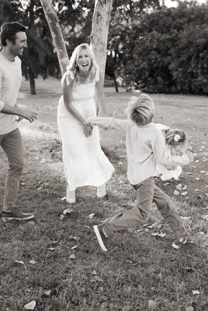 Black and white family of four during their San Diego golden hour family photography session at Guajome Park, Oceanside