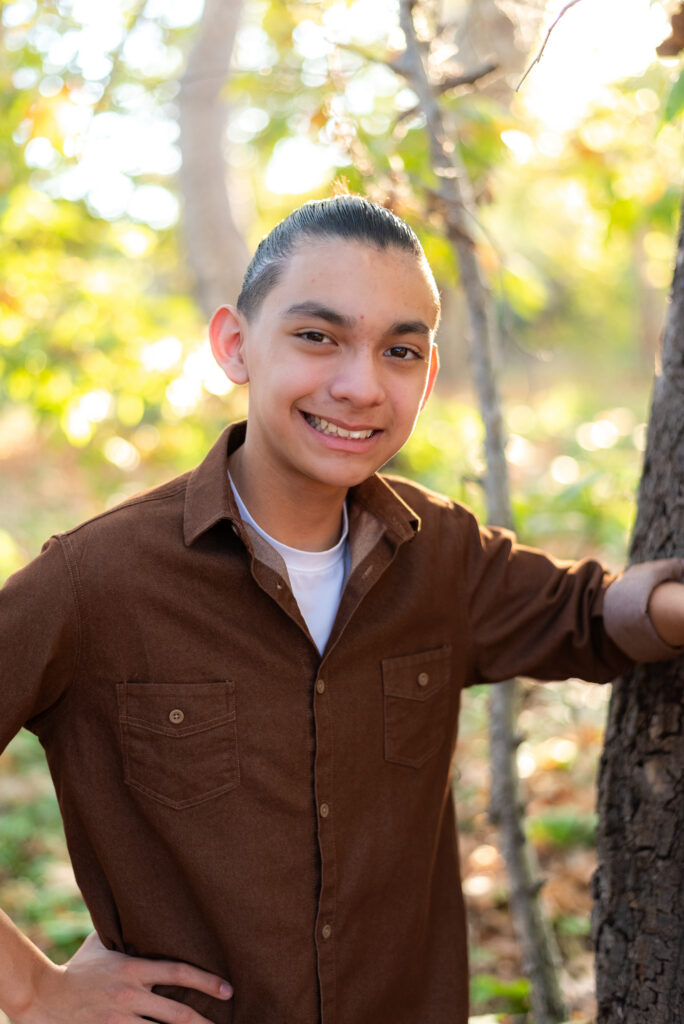 A teenage boy poses during a family session in Fallbrook, CA