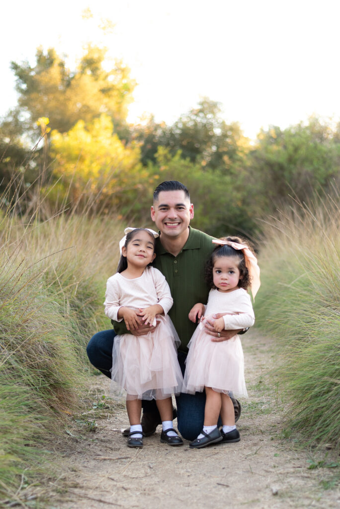Father poses with his two young daughters in Fallbrook, CA