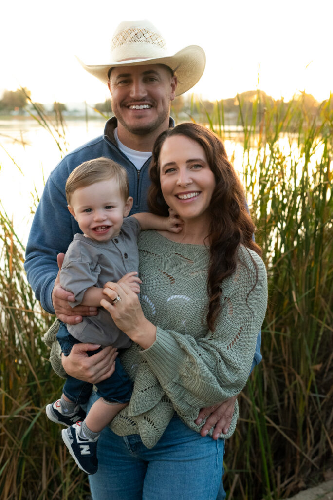 Young family smiling together during an outdoor photo session in Lodi CA