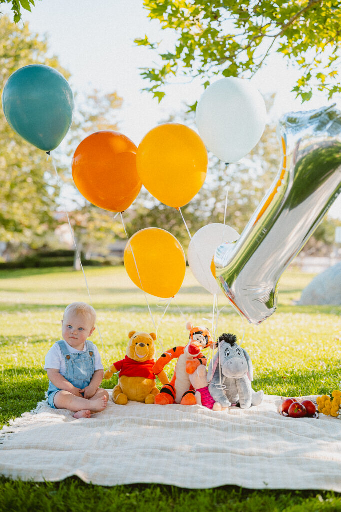 One-year-old enjoying a picnic theme cake smash session in Oceanside, CA
