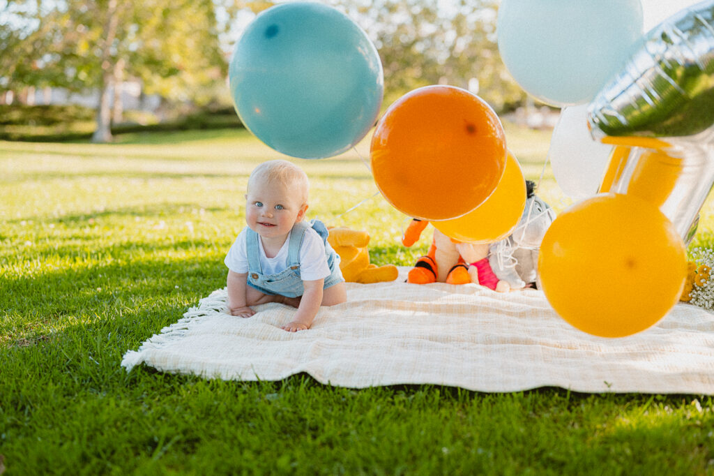 One-year-old enjoying a picnic theme cake smash session in Oceanside, CA