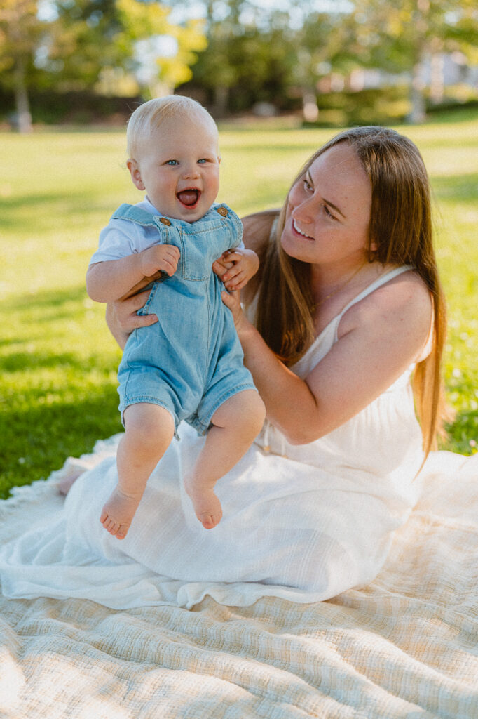One-year-old enjoying a picnic theme cake smash session in Oceanside, CA